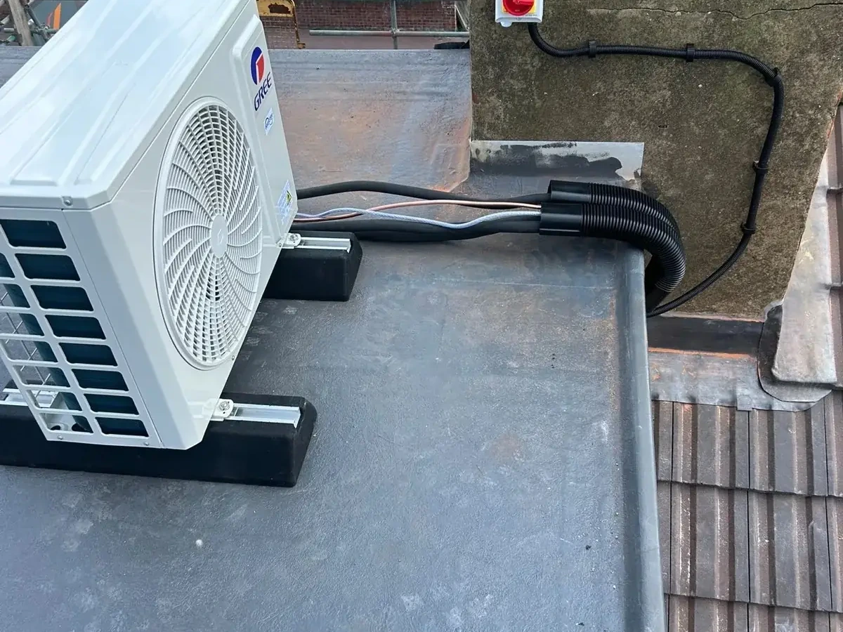 Perennia Climate Services engineer adjusting an outdoor air conditioning condenser during installation