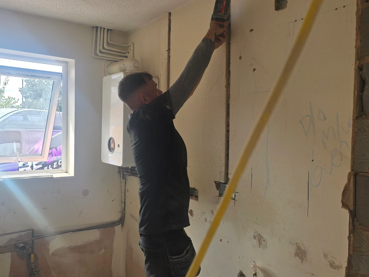 Chasing a new cable route into a stripped kitchen wall