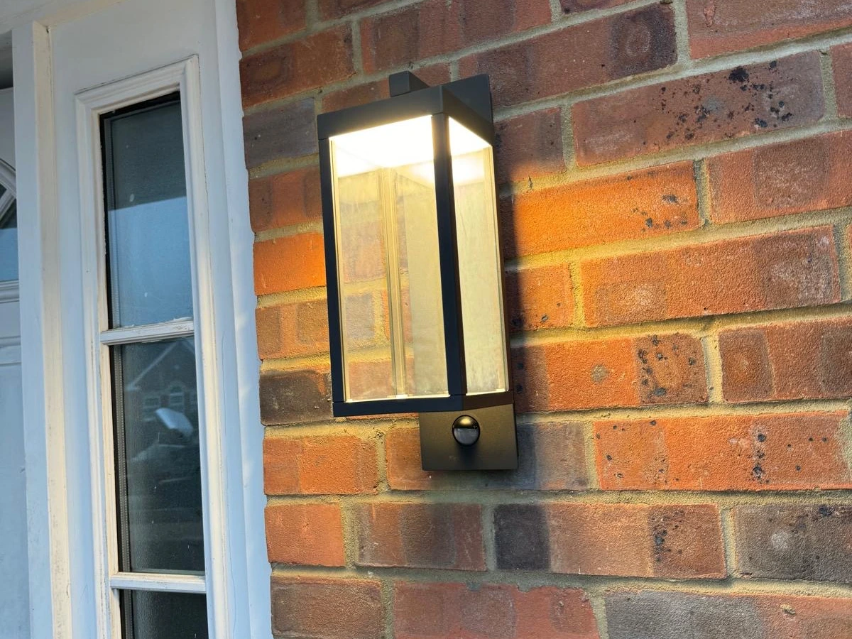 Wall lantern with PIR sensor fitted to a brick wall