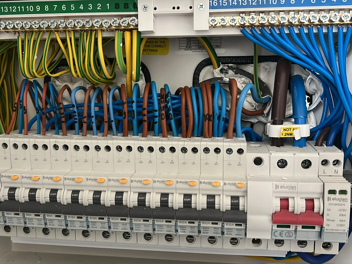 Inside a consumer unit with labelled circuit conductors