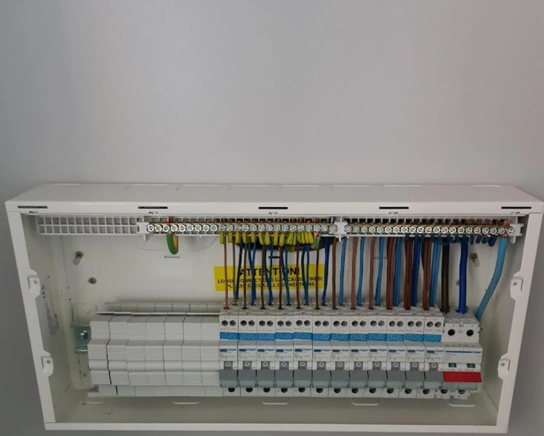 Open consumer unit with breakers wired and cables dressed in