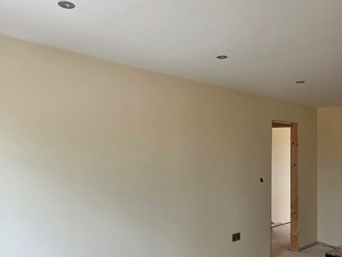 Newly decorated room with downlights and double sockets fitted