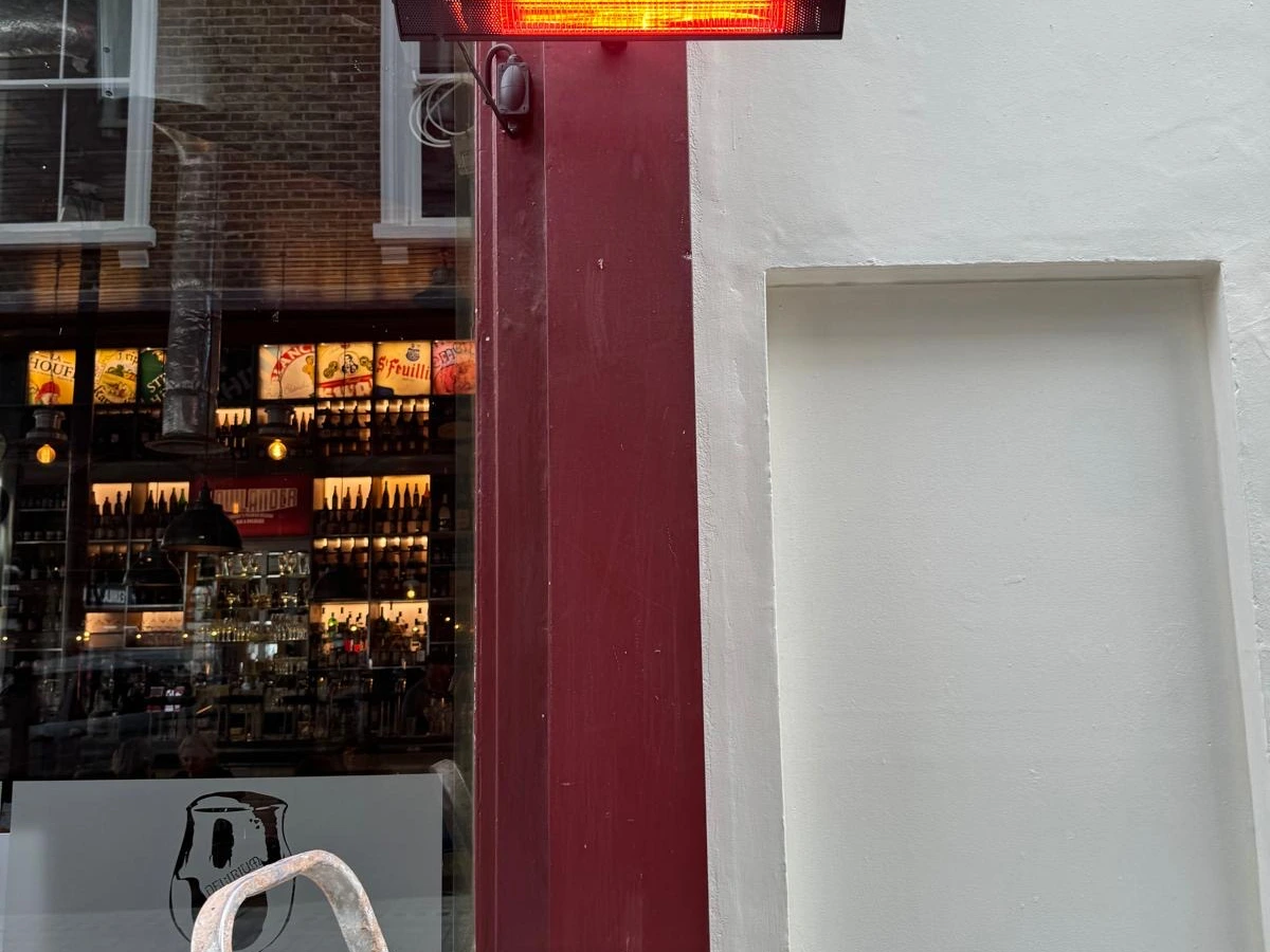 Infrared heater and isolator fitted above a shopfront doorway