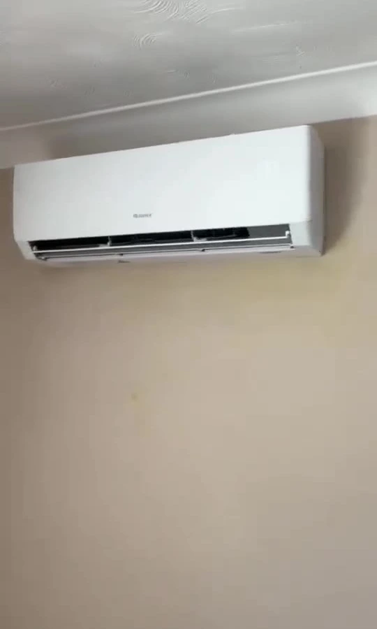 Perennia Climate Services engineer installing an outdoor air conditioning condenser on an Essex home