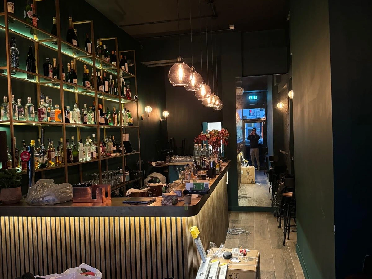 Glass globe pendants and shelf lighting in a bar fit-out
