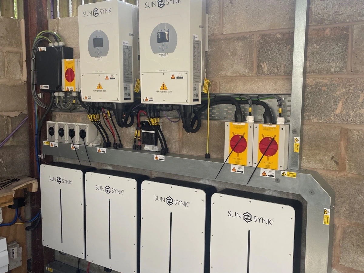 Two Sunsynk inverters above four wall-mounted battery units