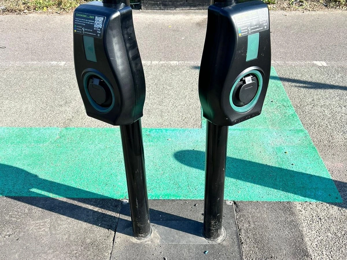 Two pedestal EV charge points on a marked charging bay